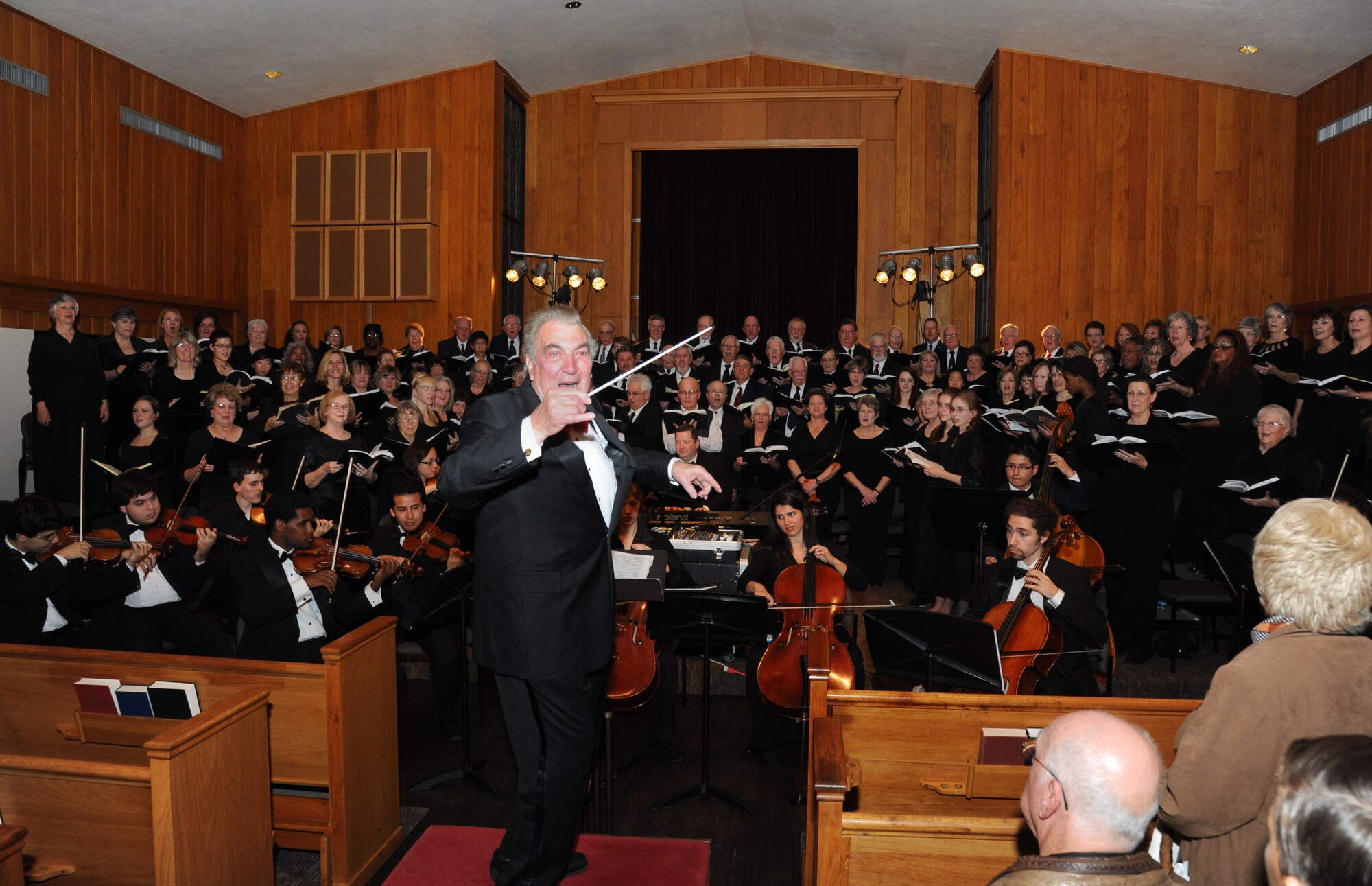 Dr. Glenn Draper, founding conductor of the Gulf Coast Messiah Chorus, is the guest conductor for the song, Hallelujah, during the Chorus’ 60th Anniversary Celebration Nov. 29, 2012, at the Triangle Chapel, Keesler Air Force Base, Miss.  Under the direction of Draper, the first performance at Keesler began a 60-year history of performances by musicians from both the military and civilian communities.  (U.S. Air Force photo by Kemberly Groue)