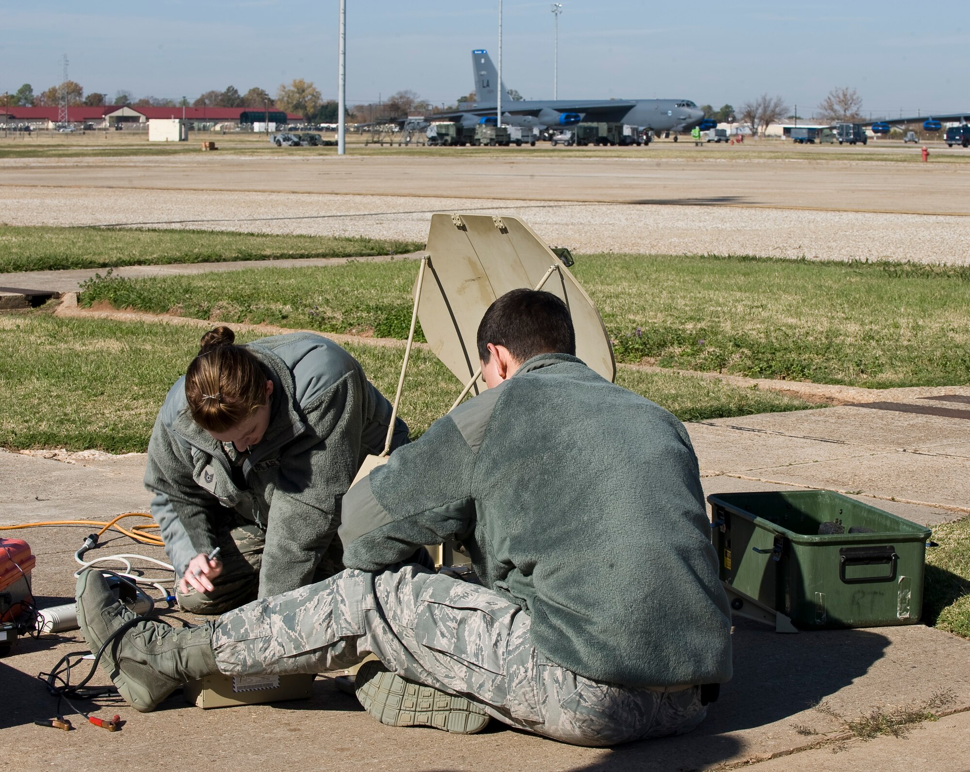 Tech. Sgt. Amber Perry, 307th Bomb Wing Command Post, left, and Airman 1st Class Stephen James, 2 BW Command Post, configure a Single Channel Anti-jam Man Portable during a Nuclear Surety Staff Assistance Visit on Barksdale Air Force Base, La., Nov. 29. The SCAMP is a satellite communication device used by ground troops for secure strategic communications. (U.S. Air Force photo/Staff Sgt. Chad Warren)