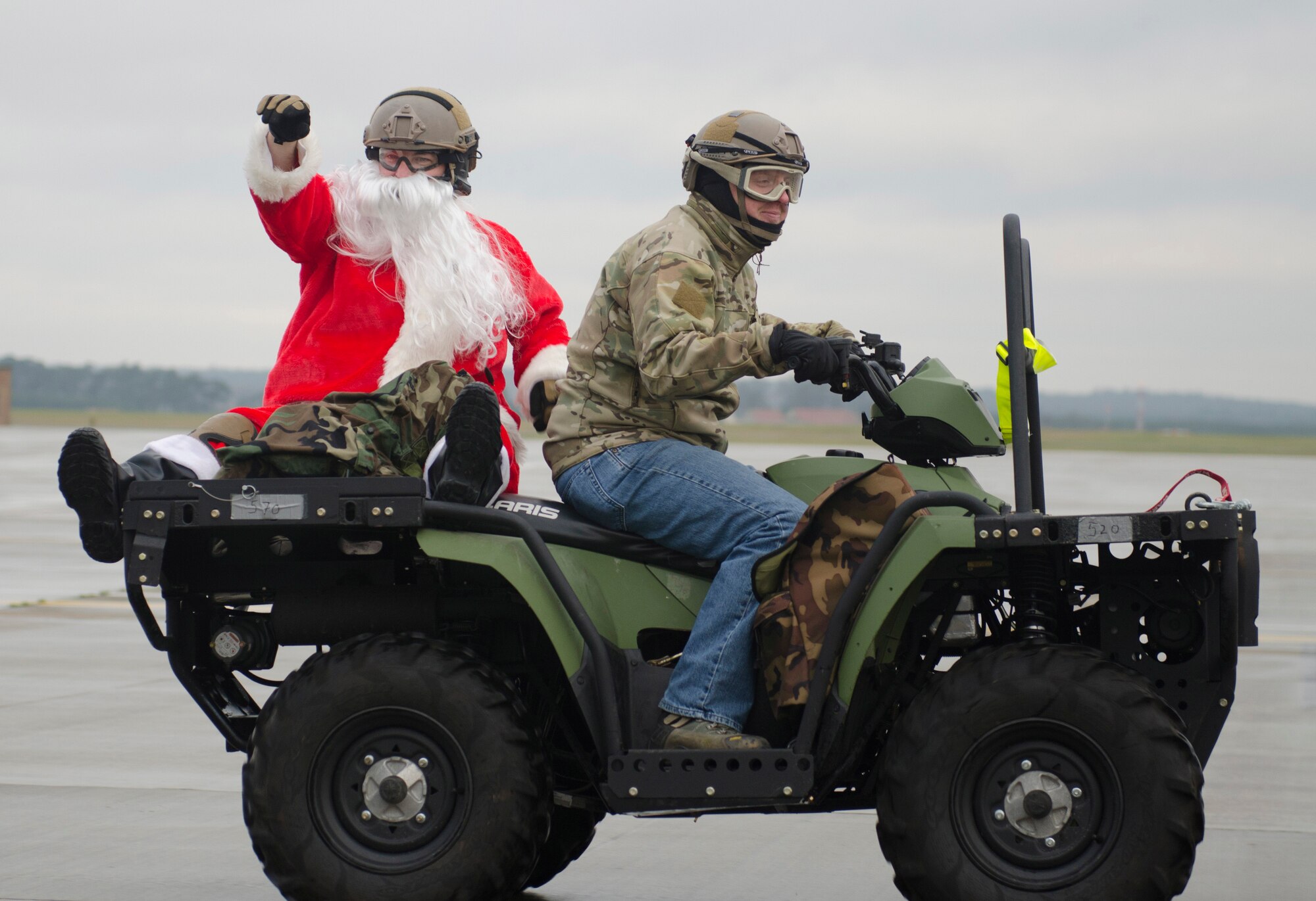 ROYAL AIR FORCE LAKENHEATH, England - Santa Claus, a North Pole native, waves to Team Lakenheath members from the backseat of an all-terrain vehicle driven by Staff Sgt. Anthony DeRoest, 56th Rescue Squadron pararescueman and native of Portland, Ore., Dec. 1, 2012. According to Claus, although the ATV is outfitted for search and rescue and patient transport, it works well for his purposes as its four-wheel drive system and rugged durability allows him to bring Christmas cheer to even his most remote customers. (U.S. Air Force photo by Staff Sgt. Stephen Linch)