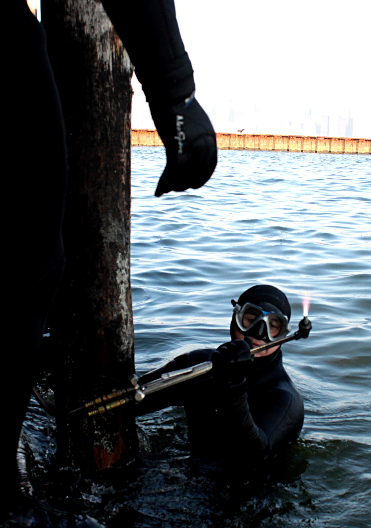 U.S. Army Pfc. Jacob Feyers, a diver attached to the Special Troops Battalion, 7th Sustainment Brigade, Fort Eustis, Va., makes repairs below water of the Army Corps of Engineers Caven Point Marine Terminal pier, Jersey City, N.J. with his welding torch Nov. 11, 2012. Feyers is part of a team of divers attached to the STB that assisted with recovery efforts in the New York Metropolitan area after the damage left by Hurricane Sandy. (U.S. Army photo by Capt. Nathan Brenan/Released)