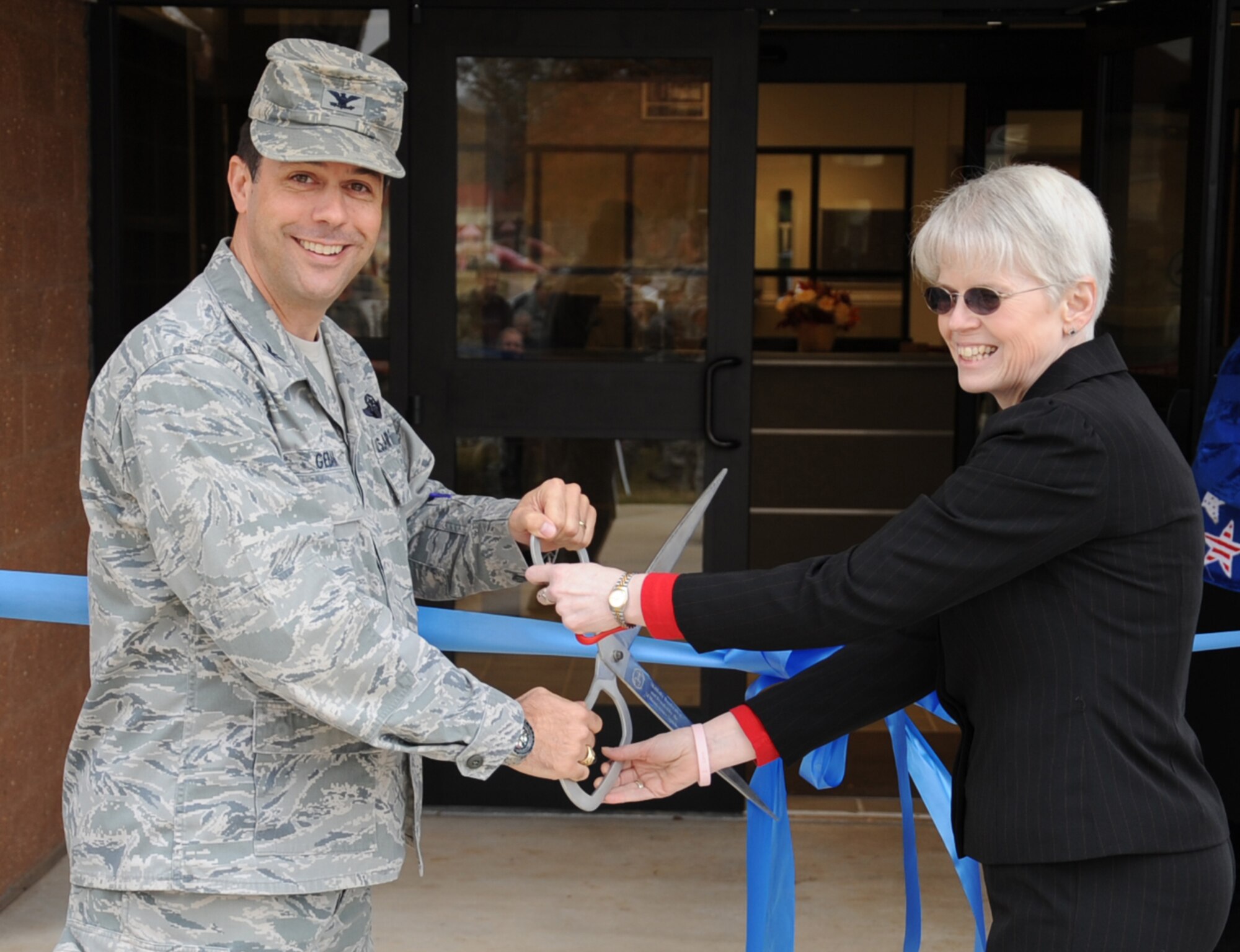 Col. Andrew Gebera (left), 2nd Bomb Wing commander, and Betsy Welch, chief of child development programs, cut a ribbon signifying the grand opening of the new Child Development Center addition on Barksdale Air Force Base, La., Nov. 30. The $5 million dollar project was developed due to the extensive waiting list the current CDC had. (U.S. Air Force photo/Senior Airman Sean Martin)