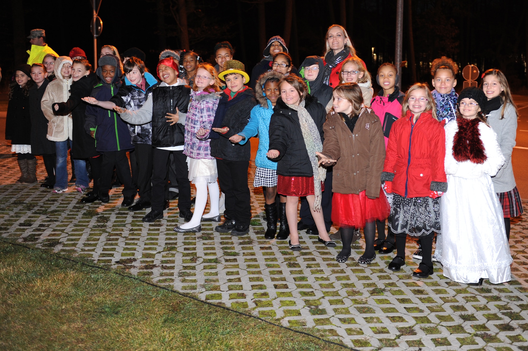 Members of the Kaiserslautern Elementary School Children’s Choir sing at the Ramstein Christmas Tree Lighting Ceremony at the Ramstein Northside Chapel on Ramstsein Air Base, Germany, Nov. 28, 2012. The tree lighting was used to kick off the Christmas holiday season. (U.S. Air Force photo/Airman 1st Class Holly Cook)
