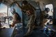 U.S. Air Force Tech. Sgt. Will Stimpson, a door gunner from the 438th Air Expeditionary Advisory Squadron, evaluates Afghan Air Force Sgt. Razeg, a gunner, while USAF Staff Sgt. Michael Dinicola, a gunner from 438th AEAS, provides over watch during a mission on an AAF Mil Mi-17 helicopter from Kabul, Afghanistan, International Airport, Nov. 29, 2012. The flight was a “check ride” mission, during which an AAF copilot and door gunner further train and qualify in their respective jobs. (U.S. Air Force photo/Tech. Sgt. Dennis J. Henry Jr.)