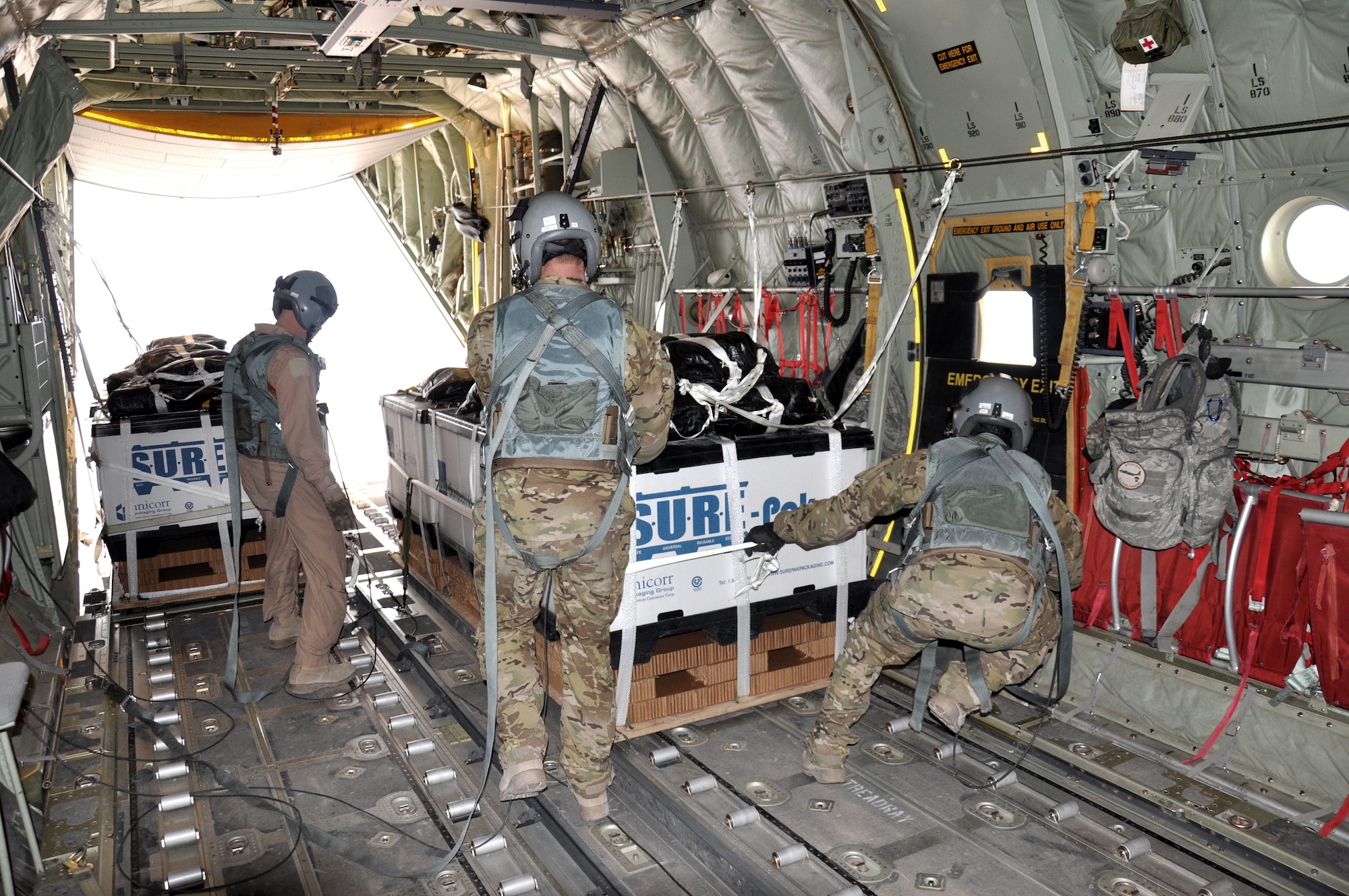 Senior Airman Dan Simonsen, Senior Master Sgt. Steve Martin and Senior Airman Marcus Wright, loadmasters with the 772nd Expeditionary Airlift Squadron, prepare to perform a Low Cost Low Altitude airdrop from the back of a C-130J in southwest Afghanistan Nov. 15. They are deployed from Dyess Air Force Base, Texas. (U.S. Air Force photo/Capt. Tristan Hinderliter)