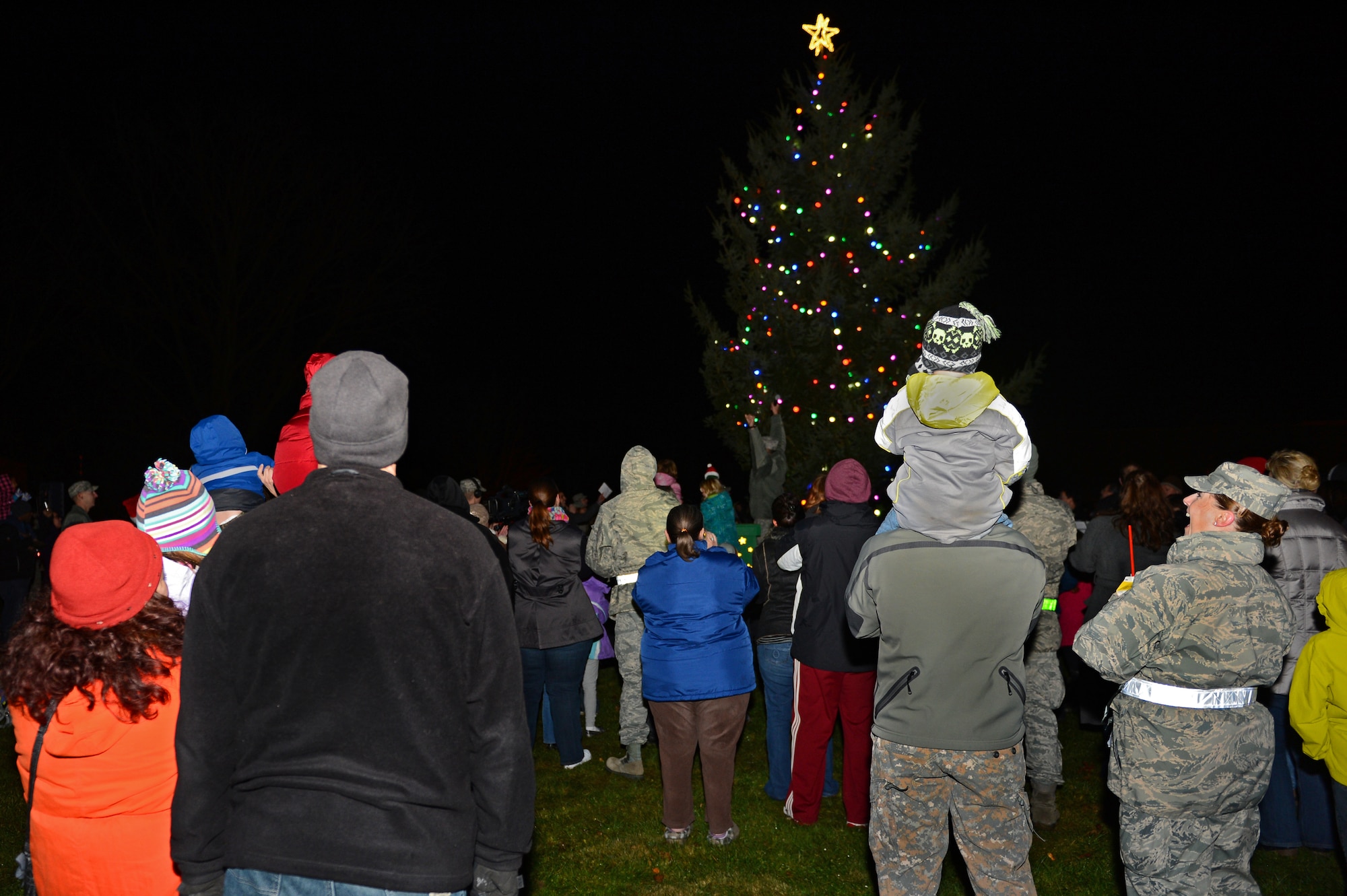 SPANGDAHLEM AIR BASE, Germany – Base community members celebrate during the Holiday Tree Lighting ceremony Nov. 29, 2012. The annual ceremony allows the community to get into the holiday spirit by enjoying snacks, refreshments and live holiday music. The 52nd Civil Engineer Squadron set up and lit the tree to usher in the holiday season. (U.S. Air Force photo by Airman 1st Class Dillon Davis/Released)