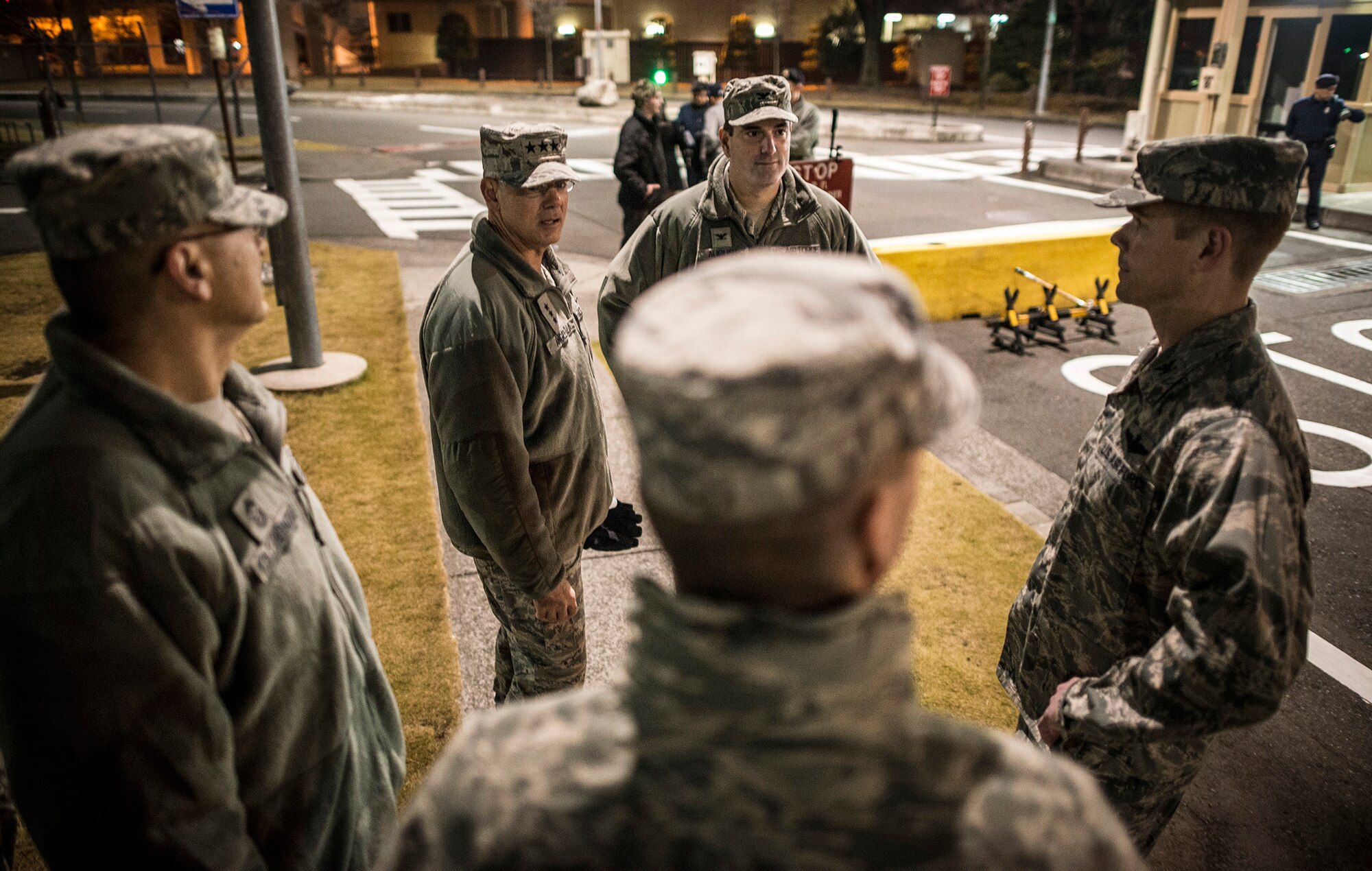 YOKOTA AIR BASE, Japan -- Lt. Gen. Sam Angelella, center left, U.S. Forces, Japan, and 5th Air Force commander, speaks with USFJ and Yokota Air Base leadership inside the Fussa Gate at Yokota Air Base, Japan, Nov. 30, 2012. Col. Mark August, center right, 374th Airlift Wing commander, took Angelella out on town patrol to an area known locally as "bar row" to show him how the social climate has changed in response to the recent curfew. (U.S. Air Force photo by Tech. Sgt. Samuel Morse)
