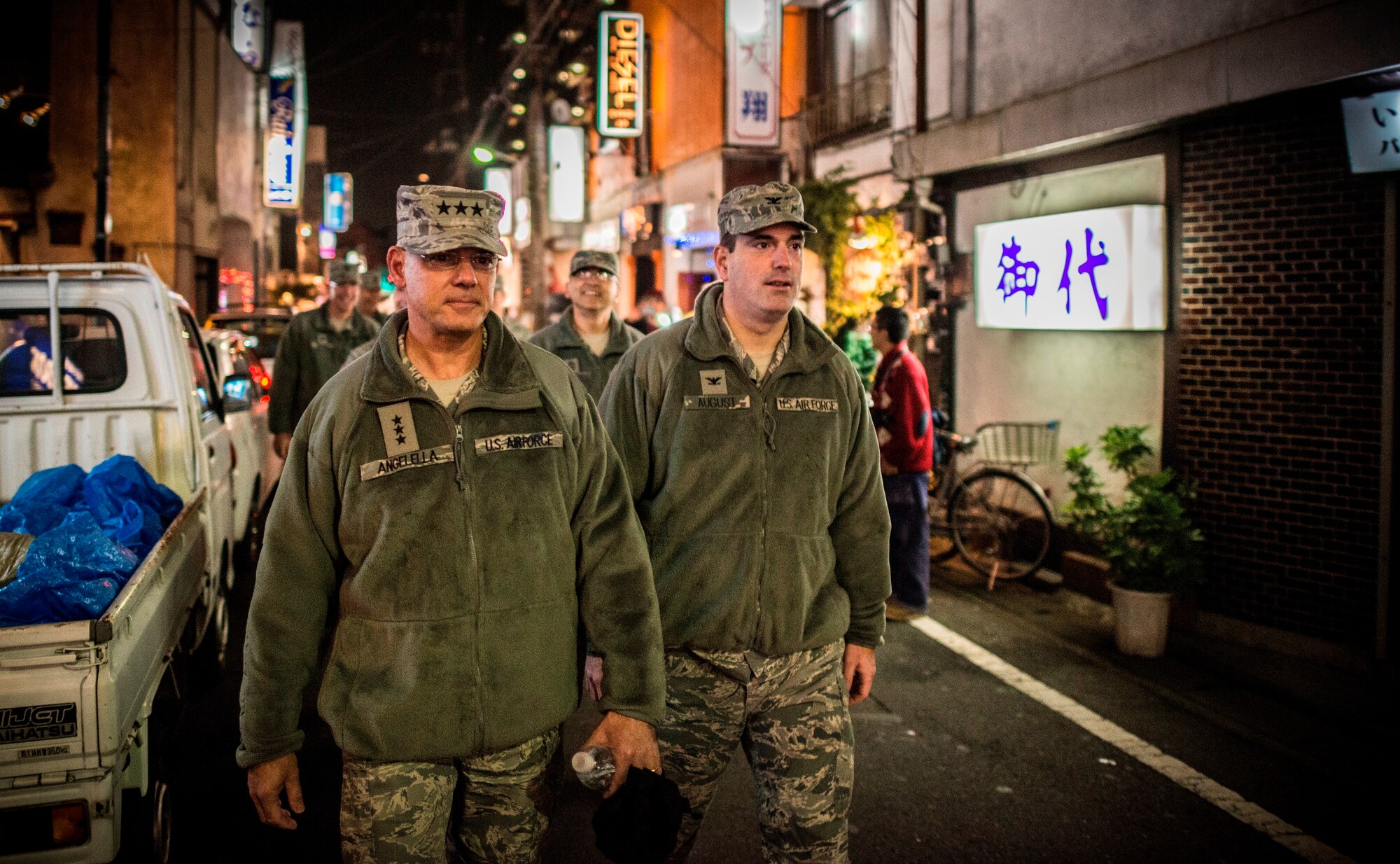 FUSSA CITY, Japan -- Lt. Gen. Sam Angelella, left, U.S. Forces, Japan, and 5th Air Force commander, and Col. Mark August, 374th Airlift Wing commander, conduct a town patrol in an area known as "bar row" in Fussa City, Japan, on Nov. 30, 2012.  The patrol was conducted to remind service members to obey the recent curfew and reassure the local community of the base's commitment to professionalism both on- and off-duty. (U.S. Air Force photo by Tech. Sgt. Samuel Morse)