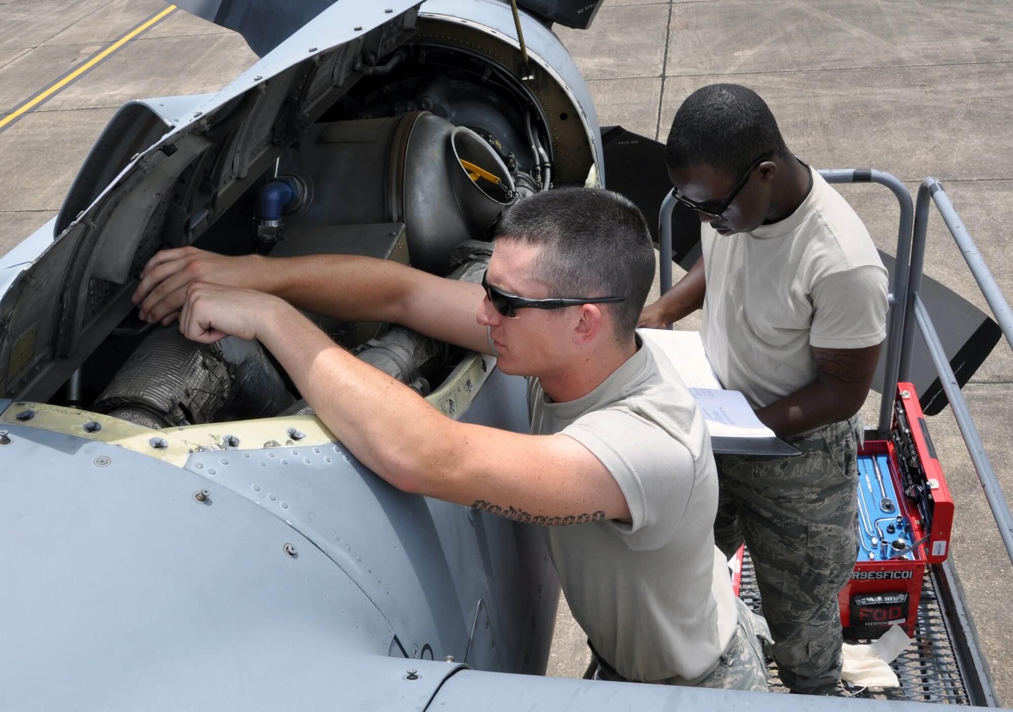 Airmen 1st Class Ian McKibben and Charles Flannigan, of the 94th Maintenance Group, work on removing the shroud around the bleed ducting in a C-130 Hercules engine at Maxwell Air Force Base July 10. Members of the 94th Airlift Wing were relocated form Dobbins ARB to Maxwell AFB as part of a mini deployment so they could continue to train and remain combat ready. (U.S. Air Force photo/Senior Airmen Elizabeth Gaston)
