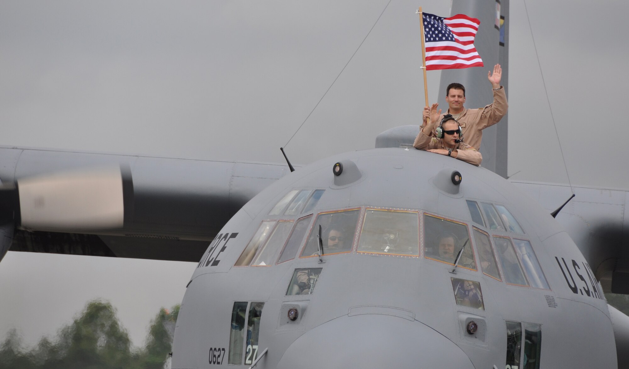 Members of the 94th Airlift Wing taxing to the runway on Dobbins Air Reserve Base are waving to family, friends and members of the wing during a send-off ceremony on May 7.  Members of the 94th Airlift Wing deployed in support of operations in the Middle East. (U.S. Air Force photo/Airman 1st Class Elizabeth Gaston)
