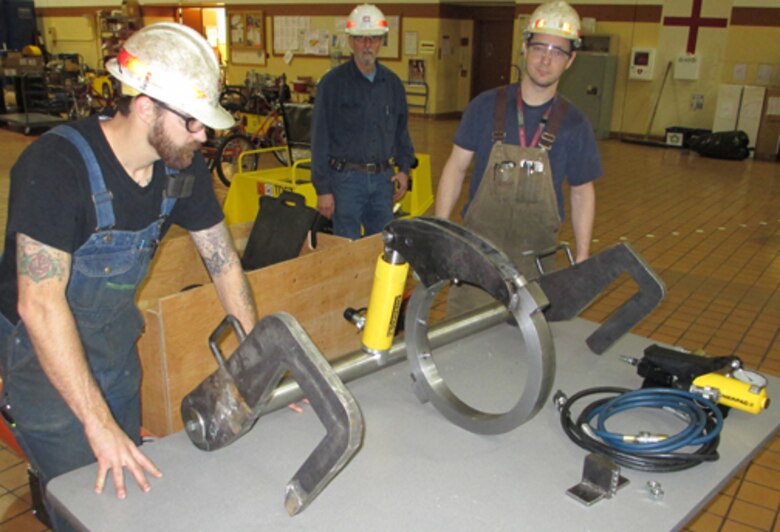 From left, Jake Keizur, Terry Best and Pete Hobart assemble one of two hydraulic wrenches they built for the downstream miter gate on The Dalles navigation lock.