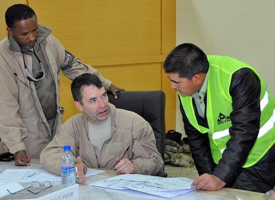 Jeff Regh, (center) an electrical engineer from Libby, Mont. deployed to Kandahar as a U.S. Army Corps of Engineers Afghanistan Engineer District-South project engineer to build high-quality facilities for the burgeoning Afghan National Security Forces. Regh normally serves at the Seattle District’s Libby Dam and Lake Koocanusa in Montana.