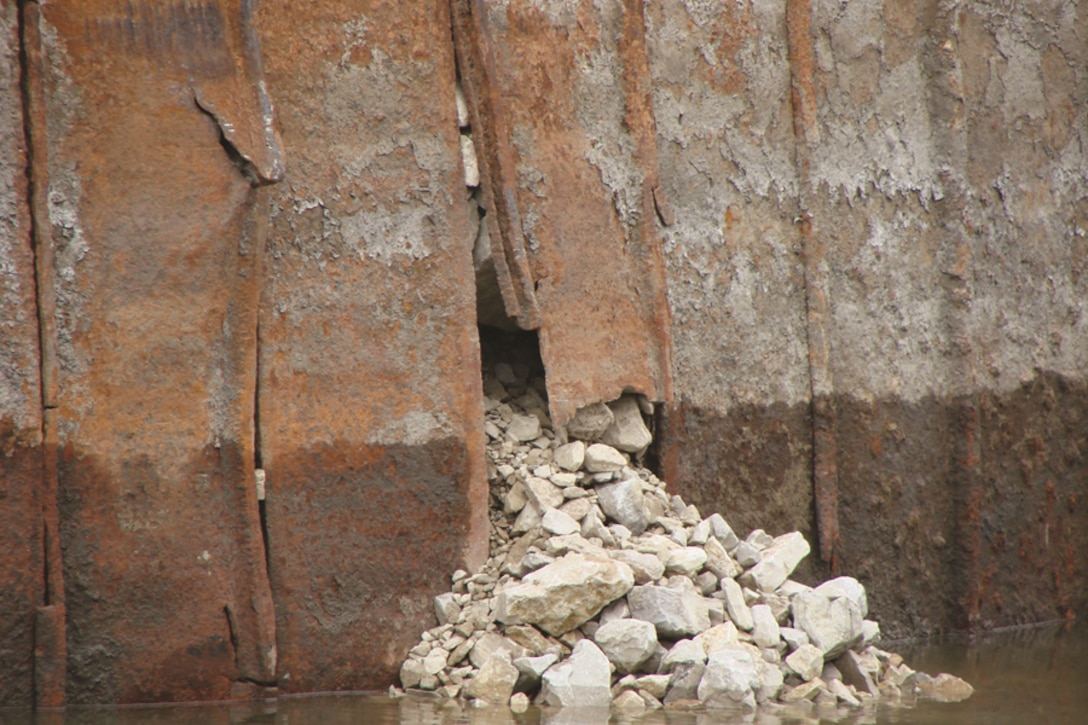 Rock spills out of a protection cell at Lock 27 in St. Louis after low water exposed vulnerable, unarmored section that was impacted by barges.