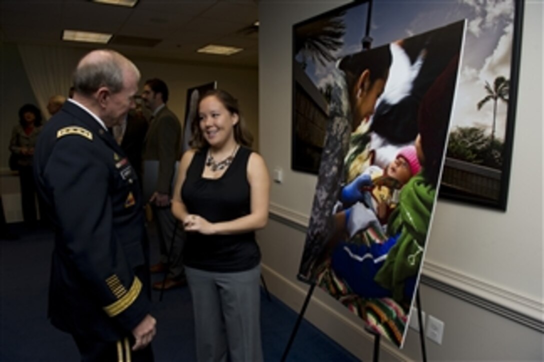 Chairman of the Joint Chiefs of Staff Gen. Martin E. Dempsey, left, speaks with Sgt. Monica Smith about her photograph during the Art in Embassies awards ceremony in the Pentagon on Nov. 30, 2012.  The contest, titled "Serving Abroad ... Through Their Eyes" in honor of Veterans Day, was sponsored by the Defense Department and the State Department's Office of Art in Embassies.  Smith was one of 12 photographers honored with a best in show award.  