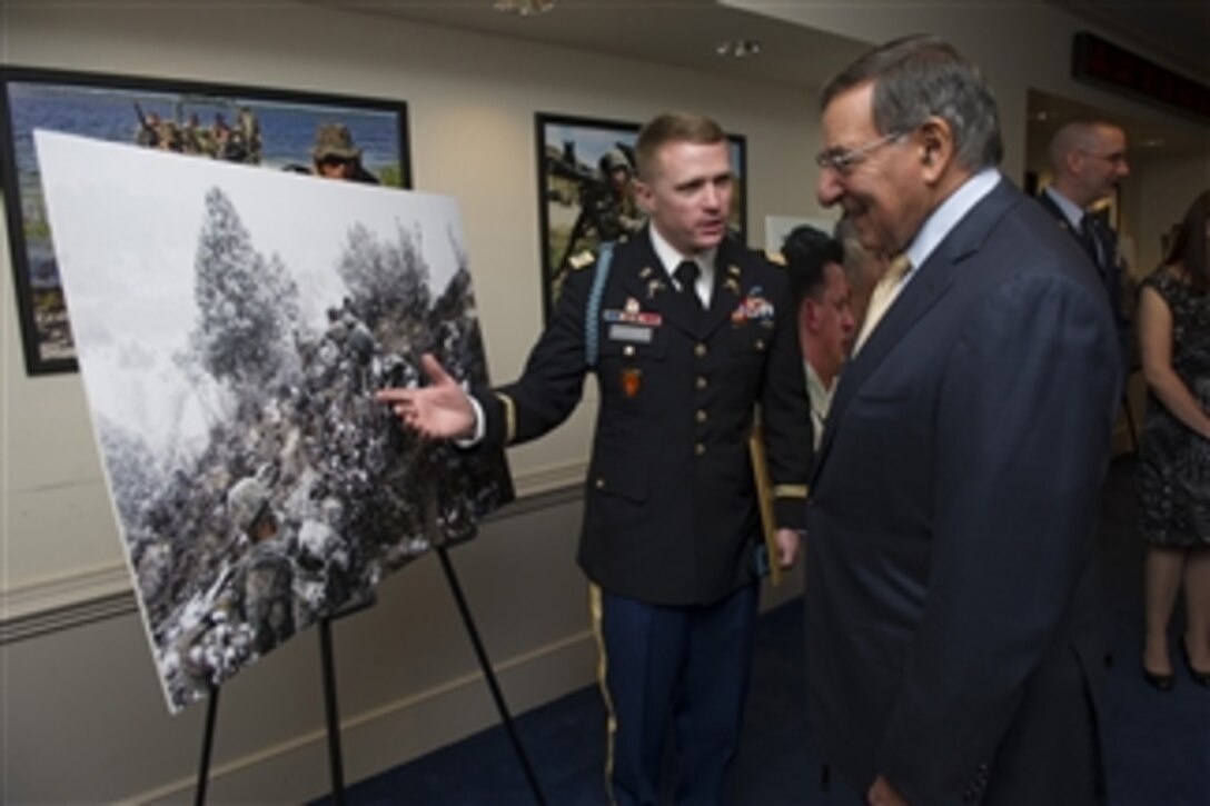 Secretary of Defense Leon E. Panetta talks with U.S. Army Capt. John Rutledge during the Art in Embassies awards ceremony in the Pentagon on Nov. 30, 2012.  The contest, titled "Serving Abroad ... Through Their Eyes" in honor of Veterans Day, was sponsored by the Defense Department and the State Department's Office of Art in Embassies.  Rutledge was one of 12 photographers honored with a best in show award.   