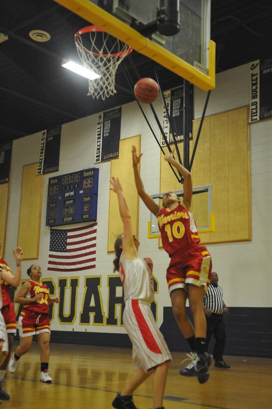 Marquis, a junior player for Quantico Middle/High School Lady Warriors Basketball Team, shoots over an opponent during their season opener against the Grace Preparatory School Warriors in Stafford on Friday. After being up by 28 points in the third quarter, Paul Roy, head coach for the Lady Warriors, decided to focus his teams’ attention on mastering the fundamentals.