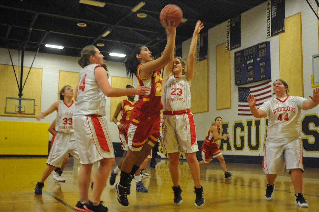 Cheyanne, junior player for Quantico Middle/High School Lady Warriors Basketball Team, has no problem shooting over three of her opponents during their season opener against the Grace Preparatory School Warriors in Stafford on Friday. By halftime, the Lady Warriors had taken the lead over Grace Prep, 28-0.