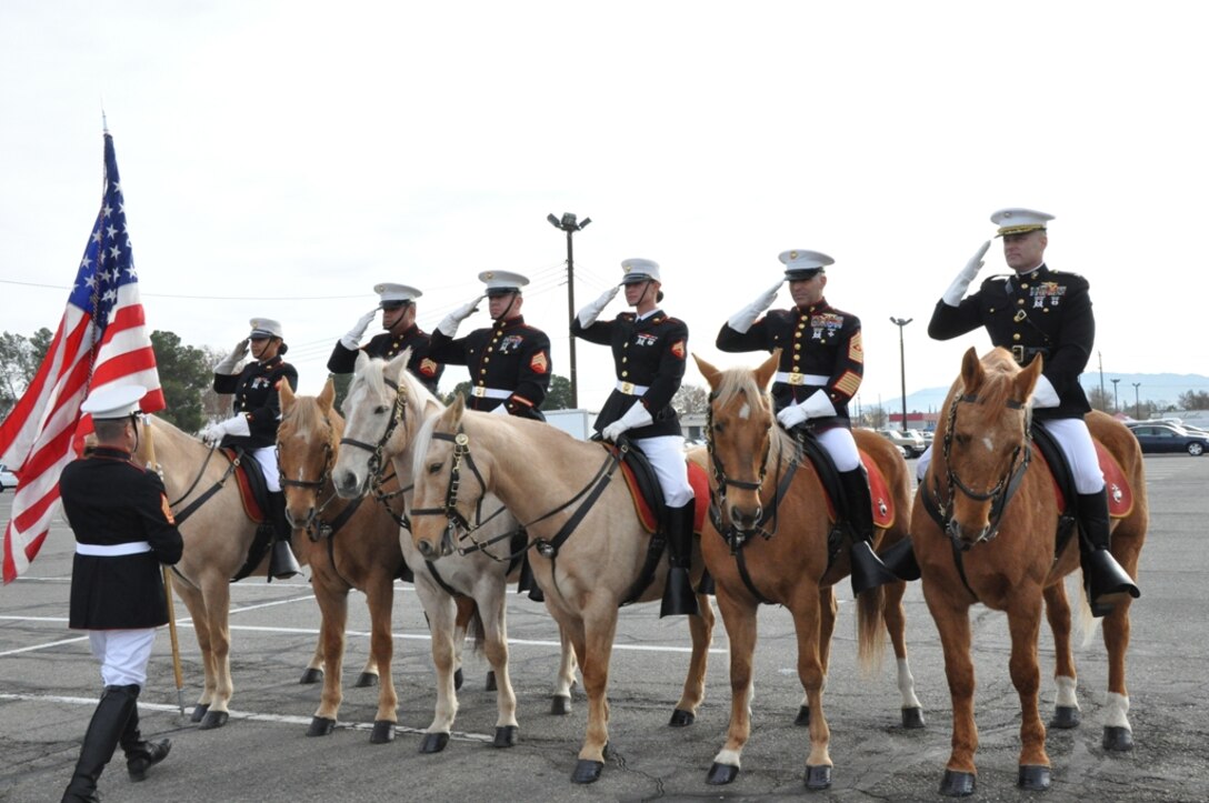 The Marine Corps Mounted Color Guard holds a formation as the Nation Colors are being presented to Sgt. Edgar Torrbalba for the Victorville Christmas parade Dec. 1 in Victorville, Calif. The MCG honors the national colors with a salute, as tradition, before every event. 