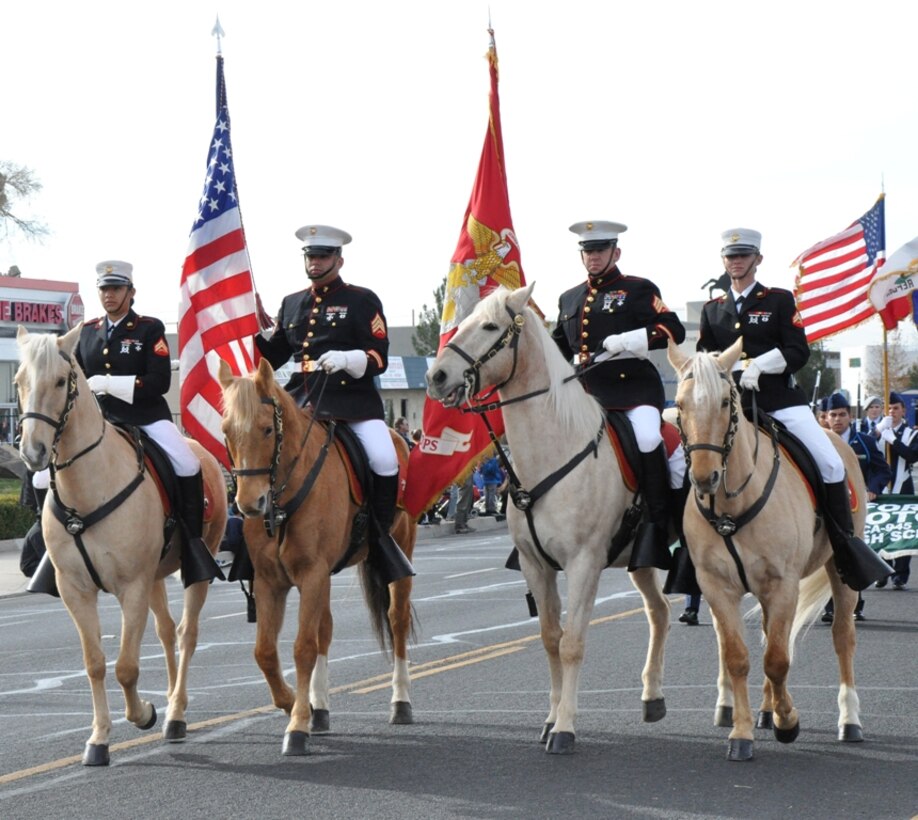 Members of the Marine Corps Mounted Color Guard walk their horse down 7th street in the Victorville Christmas parade Dec. 1. The MCG spend time prior to their event preparing their horses to ensure they perform well.