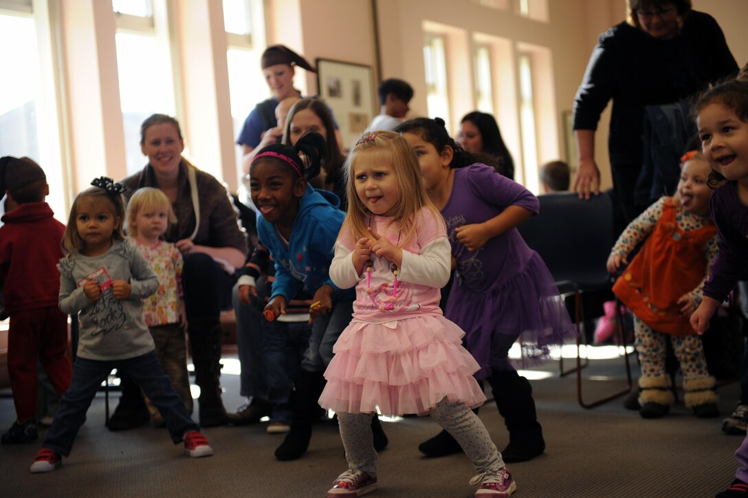 Forty-eight children dance to music by the Marine Corps Base Quantico Band Jazz Ensemble during Books and Breakfast on Friday at the base library. Forty-eight children attended to enjoyed food, jazz music, dancing and a story.