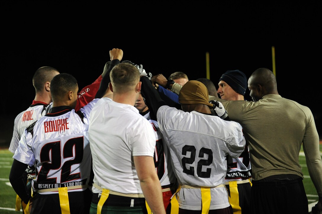 The Headquarters and Service Battalion Demons huddle before the start of their intramural flag football game against the Marine Corps Helicopter Squadron One on Nov. 15 at Butler Stadium. HMX-1 dominated the game with a 44-0 win.