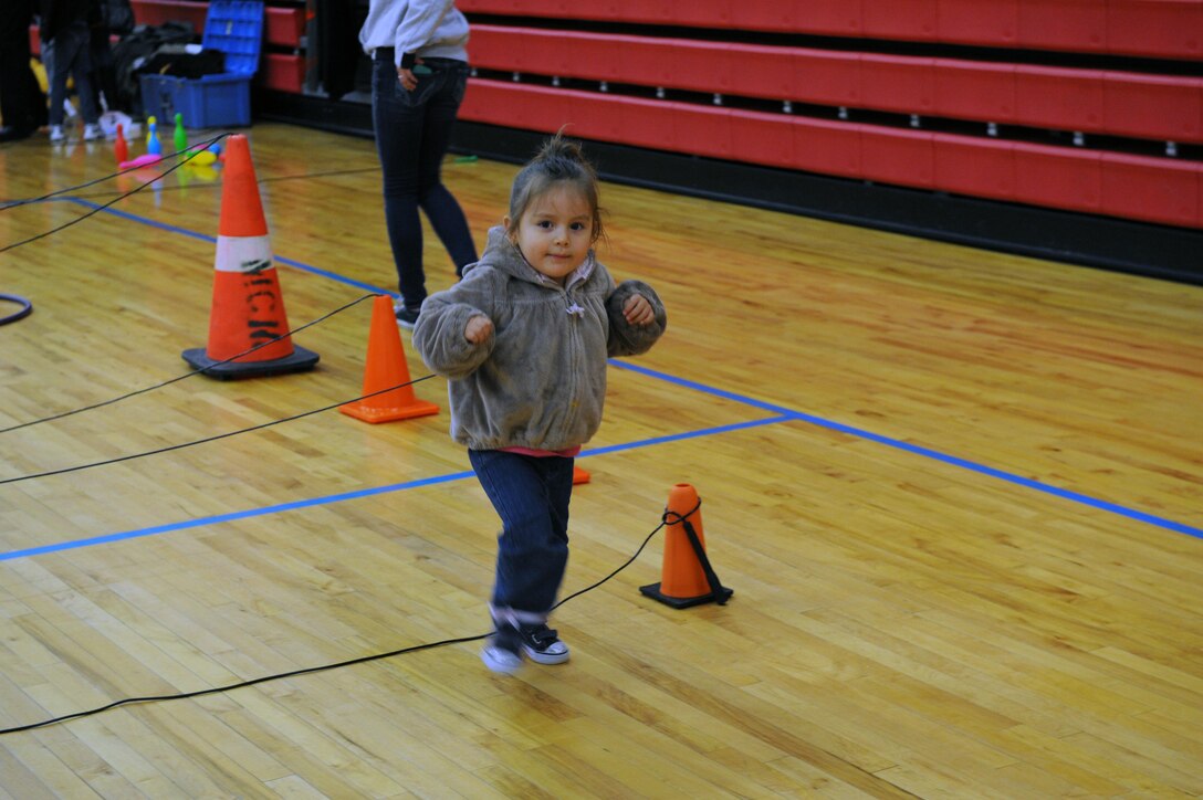 Helena, 2, jumps over the obstacle course during the first USMC Kids Birthday Bash was held at Barber Physical Activity Center on Nov. 8. Children participated in a ring toss, bingo, an obstacle course with uniform dress up and a cake cutting. (U.S. Marine Corps photo by Lance Cpl. Tabitha Bartley/released)