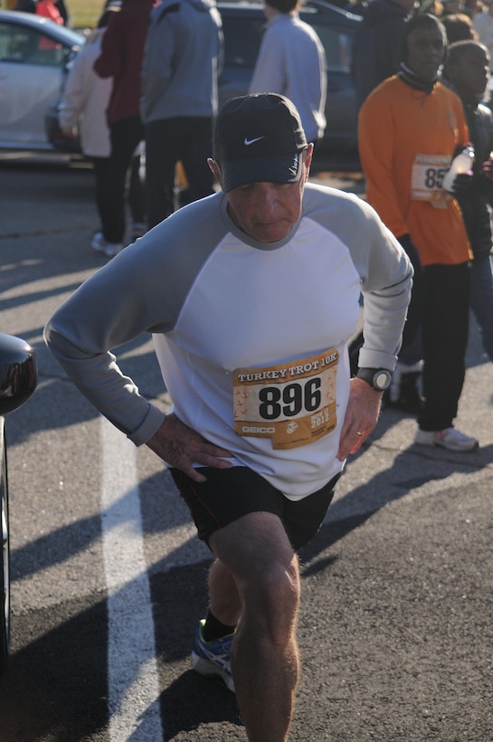 MARINE CORPS BASE QUANTICO, Va. –Larry Ratliff, a 65 year old Manassas native, carefully stretches prior the 28th Marine Corps Marathon Turkey Trot held aboard Marine Corps Base Quantico on Nov. 17. Ratliff has participated in many of the MCM events and ran this year with his daughter.
