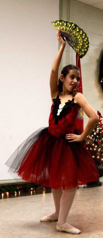 A ballerina poses with Spanish flair during the Tarawa Terrace Community Center Holiday Tree Lighting Ceremony at the Marine Corps Base Camp Lejeune housing community center Dec. 1. Young dancers from the community center’s Dance With Me Academy provided entertainment for the event’s patrons throughout the evening.