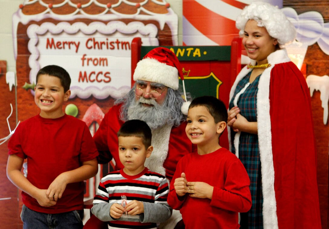 Santa and Mrs. Claus pose for a picture with three children during the Tarawa Terrace Community Center Holiday Tree Lighting Ceremony at the Marine Corps Base Camp Lejeune housing community center Dec. 1. As usual, Santa was a huge hit at the event as people waited in long lines to get a picture with him.