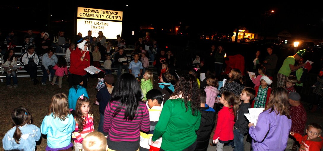 Parents and children sing Christmas carols together during the Tarawa Terrace Community Center Holiday Tree Lighting Ceremony at the Marine Corps Base Camp Lejeune housing community center Dec. 1. The event was a big hit, as an estimated 360 people were in attendance for the holiday festivities.