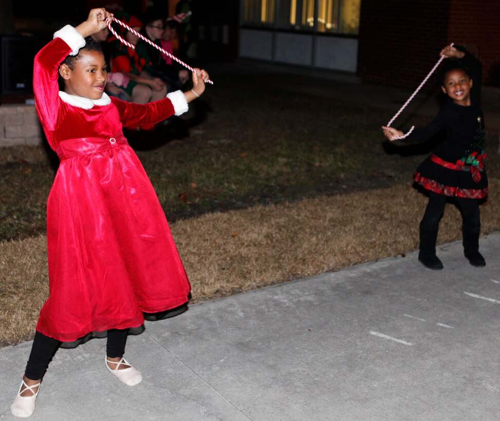 Two young dancers perform with candy-cane props during the Tarawa Terrace Community Center Holiday Tree Lighting Ceremony at the Marine Corps Base Camp Lejeune housing community center Dec. 1. Young entertainers from the community center’s Dance With Me Academy provided pleasant diversions from the winter chill for the event’s patrons throughout the evening.