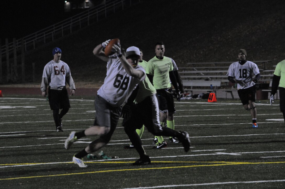 A player for Marine Corps Intelligence Activity’s flag football team takes one final step after having his flags snatched during the final game of the season against Weapons Training Battalion at Butler Stadium on Nov. 27. The final score of the game was WTBN 26, MCIA 7.