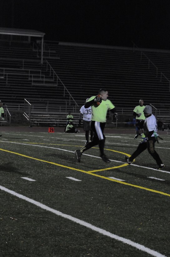 A player for Weapons Training Battalion’s flag football team takes one final step after having his flags snatched during the final game of the season Marine Corps Intelligence Activity at Butler Stadium on Nov. 27. The final score of the game was WTBN 26, MCIA 7.
