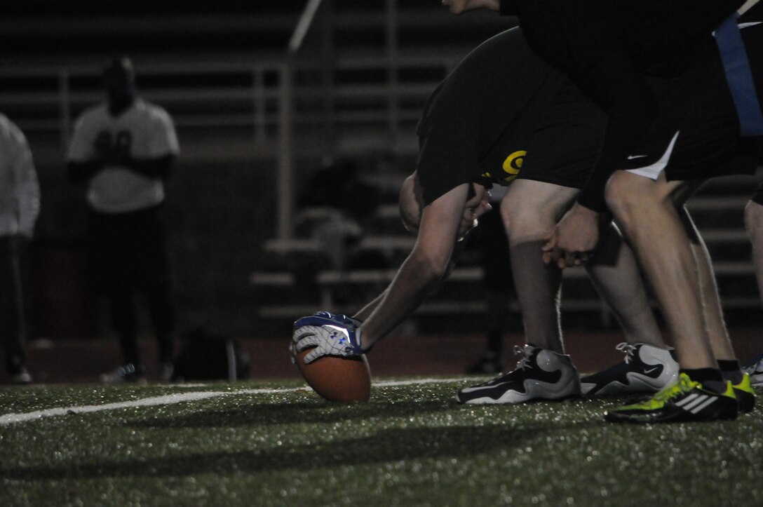 A player for Headquarters and Service Battalion’s prepares to hike the ball during an intramural game at Butler Stadium on Nov. 19. The teams who compete in the American League consist of Marines as well as civilians.