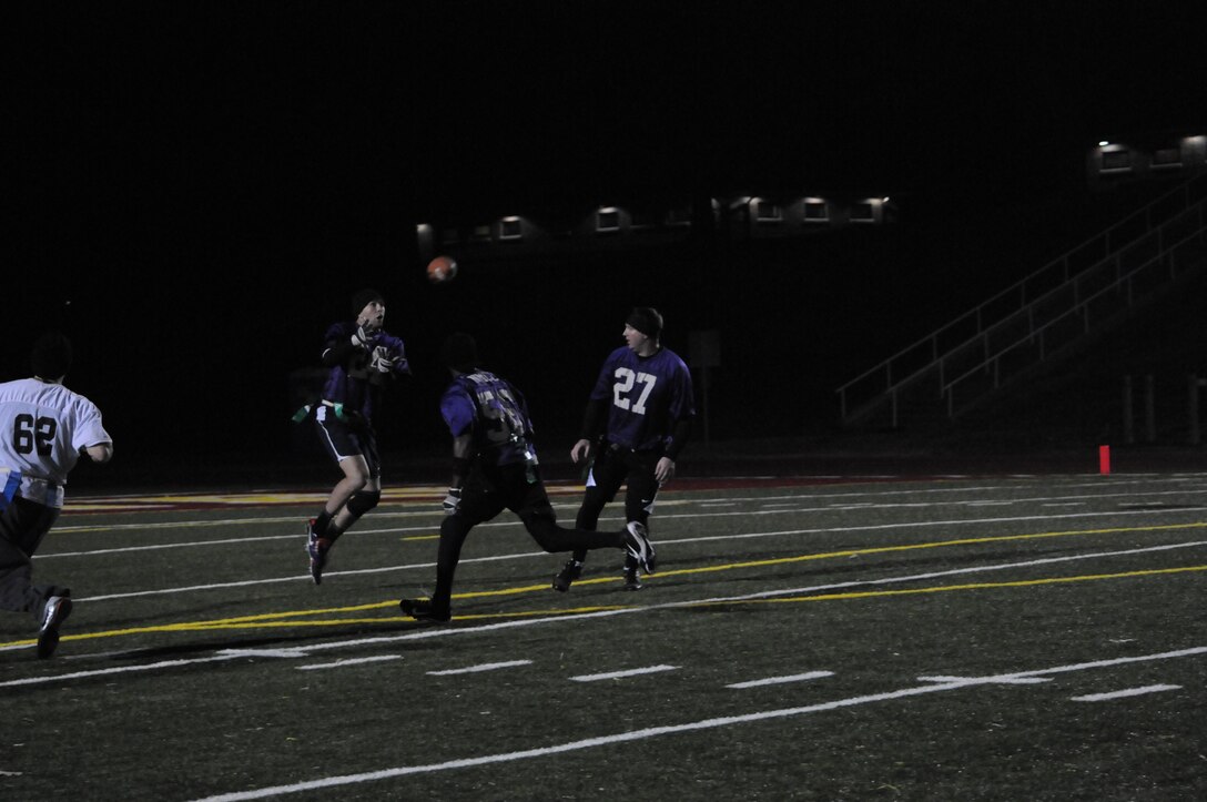 A player for Marine Corps Intelligence Agency’s flag football team leaps to catch the ball during an intramural game at Butler Stadium on Nov. 19. The teams who compete in the league consist of Marines as well as civilians.