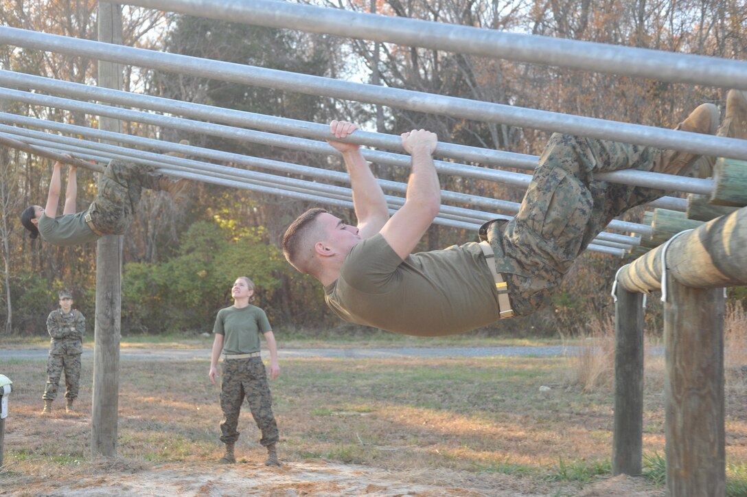 College students in the Naval ROTC program participate in a friendly competition, racing through the obstacle at Camp Upshur on Saturday. The winners of the competition took a well needed rest, while the other teams jogged two laps around the obstacle course. 