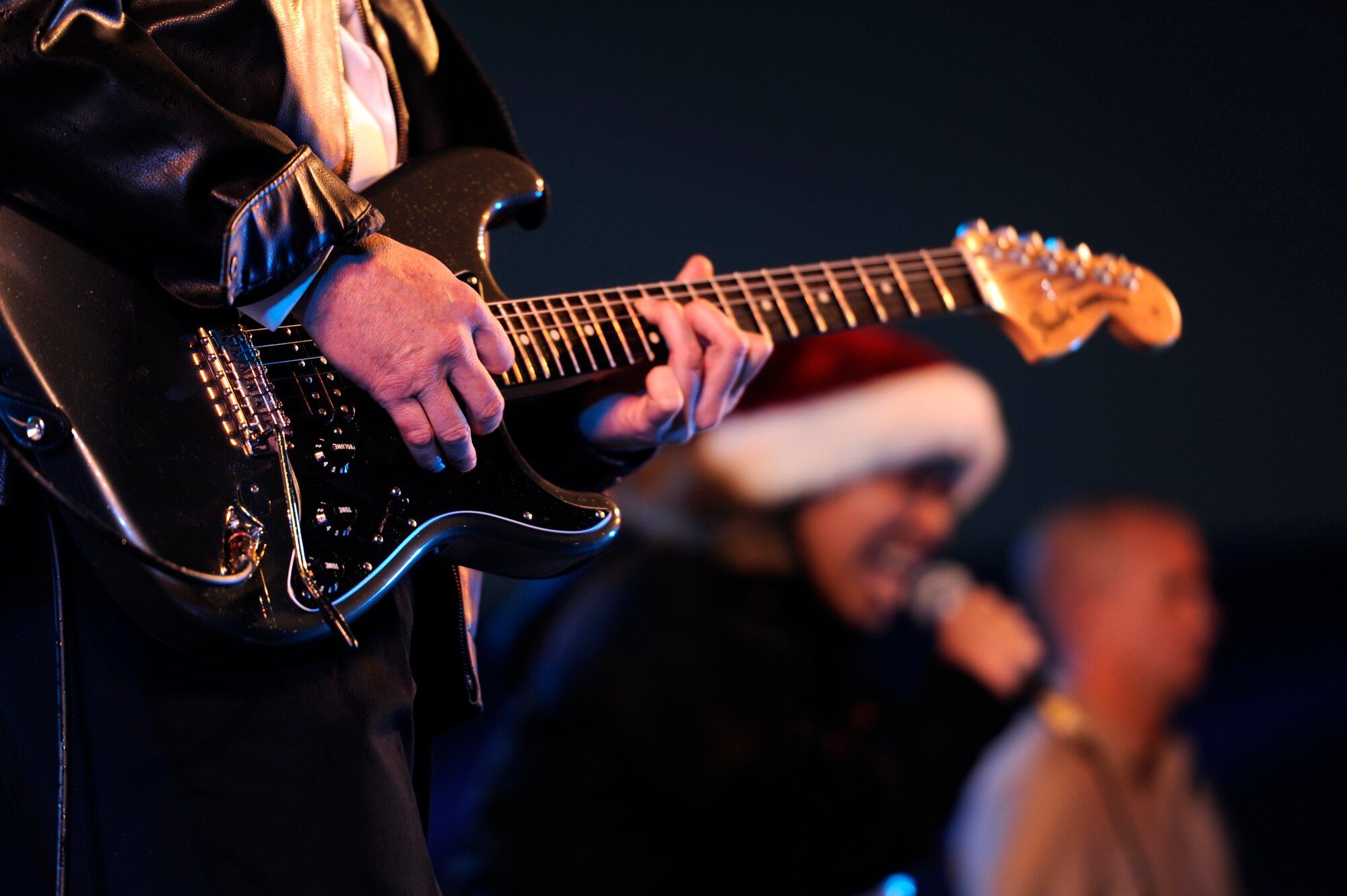 Members of the rock band 9 Long Lives perform during the Tinsel Town holiday festival on Kadena Air Base, Japan, Dec. 1, 2012. Despite dark skies and a constant Okinawan drizzle in the air, the event gave a merry light to the crowd with games, children's rides, concessions, prize giveaways and concerts by several bands including country music star Trace Adkins during his USO tour. (U.S. Air Force photo/Senior Airman Maeson L. Elleman)