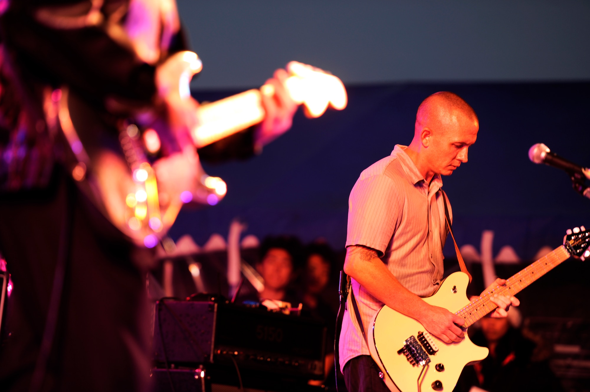 Billy Gillenwater and Michael Joiner, both guitarists for the band 9 Long Lives, perform "Johnny Be Good" for the crowd during the Tinsel Town holiday festival on Kadena Air Base, Japan, Dec. 1, 2012. The event featured roughly 65 separate vendors, organizations, crafters and volunteers from on- and off-base facilities, promoting a positive relationship with service members and the local community. (U.S. Air Force photo/Senior Airman Maeson L. Elleman)