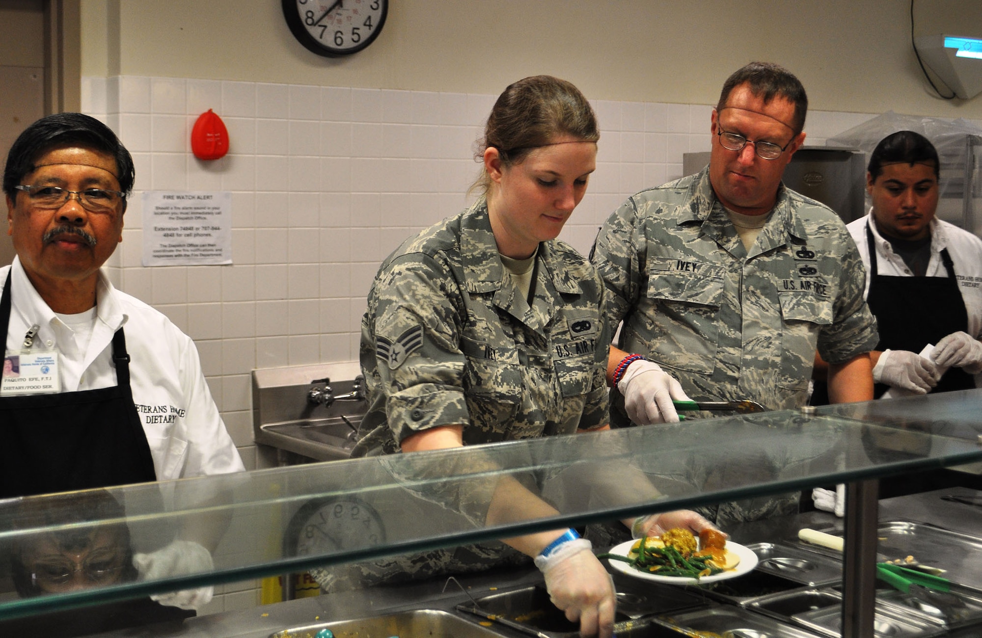 TRAVIS AIR FORCE BASE, Calif. -- Airmen from the 349th Air Mobility Wing "Give Thanks' by serving dinner to these veterans who have paved the way for the military we have today. Along with their friends and family, they share fellowship and a scrumptious turkey dinner with the men and women who, happily, shared there military stories and experiences.  (U.S. Air Force photo / Senior Master Sgt. Ellen Hatfield) 