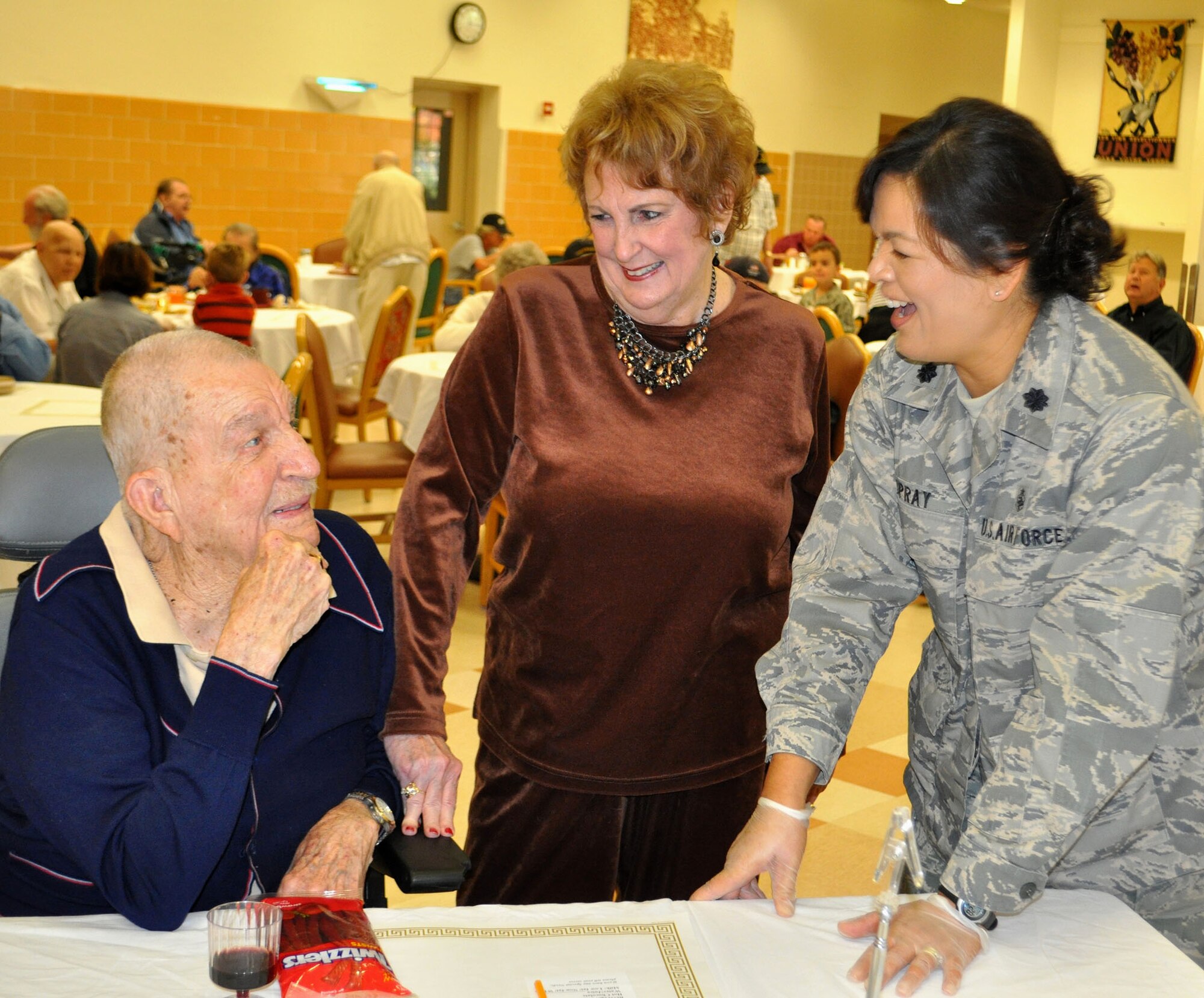 TRAVIS AIR FORCE BASE, Calif. -- Airmen from the 349th Air Mobility Wing "Give Thanks' by serving dinner to these veterans who have paved the way for the military we have today. Along with their friends and family, they share fellowship and a scrumptious turkey dinner with the men and women who, happily, shared there military stories and experiences.  (U.S. Air Force photo / Senior Master Sgt. Ellen Hatfield) 