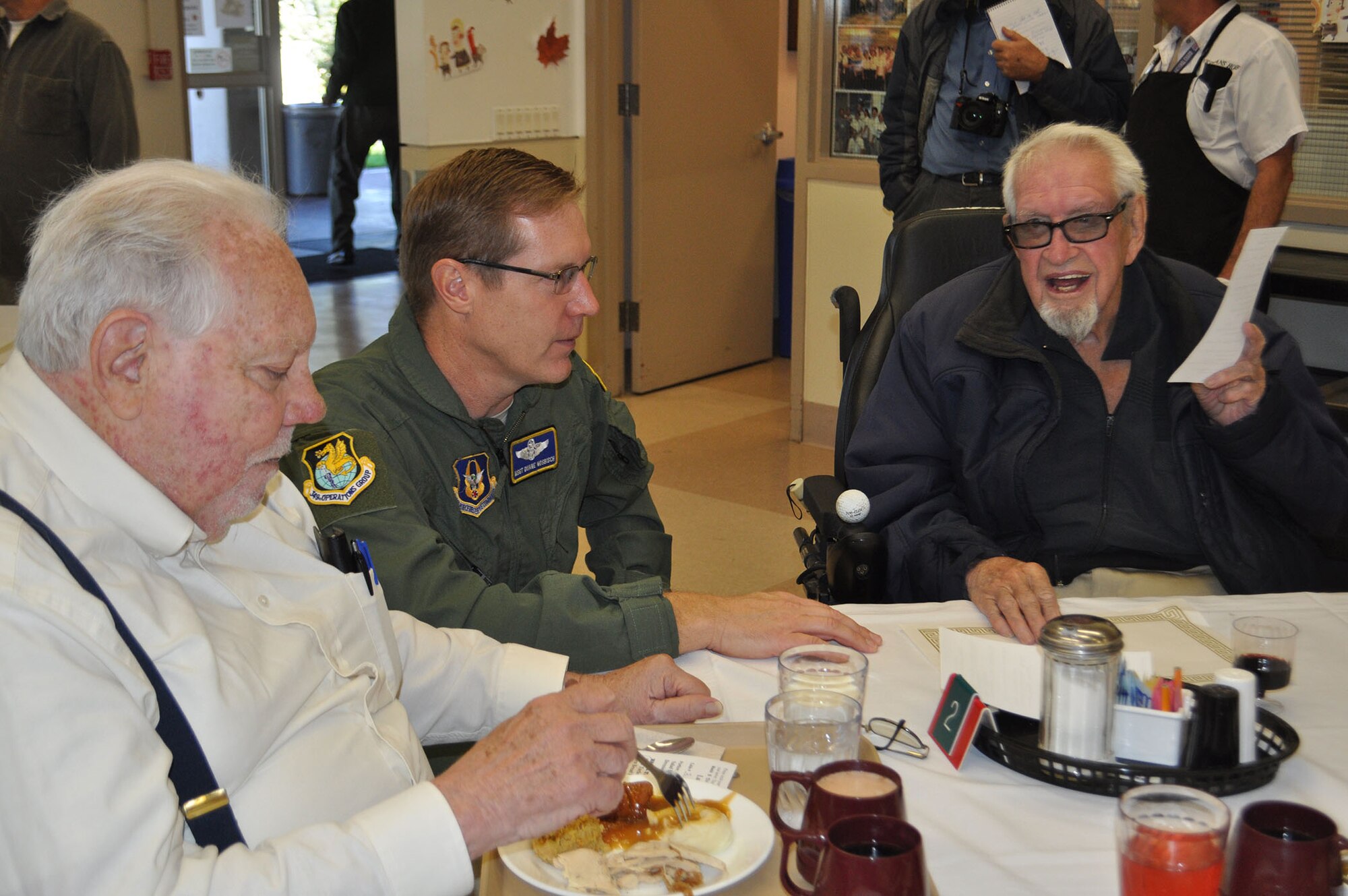 TRAVIS AIR FORCE BASE, Calif. -- Airmen from the 349th Air Mobility Wing "Give Thanks' by serving dinner to these veterans who have paved the way for the military we have today. Along with their friends and family, they share fellowship and a scrumptious turkey dinner with the men and women who, happily, shared there military stories and experiences.  (U.S. Air Force photo / Senior Master Sgt. Ellen Hatfield) 
