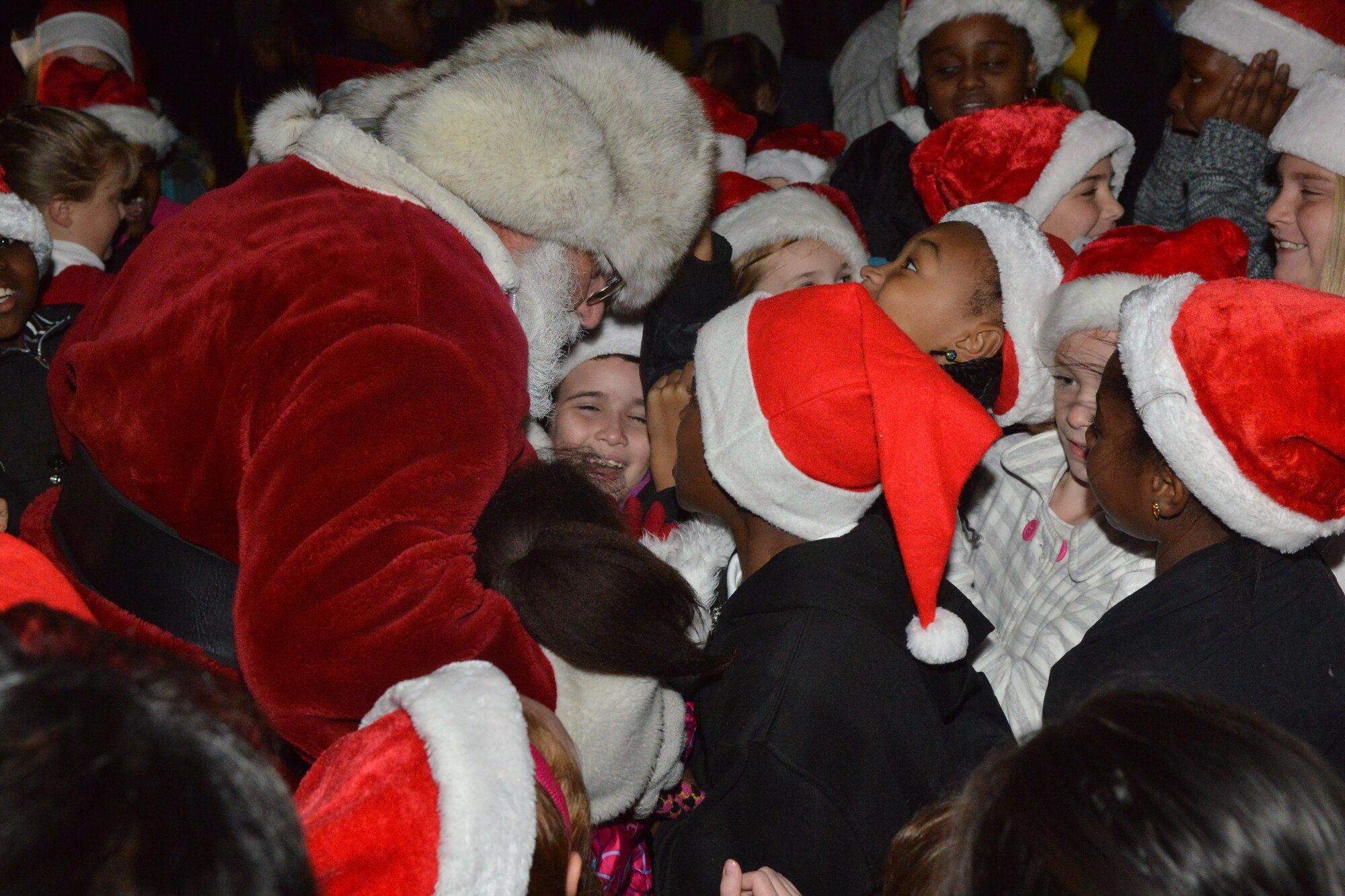 Santa Claus surprises a group of elementary carolers at the Shaw Christmas tree lighting, Shaw Air Force Base, S.C. Nov. 29, 2012. The celebration attracted more than 300 participants. (U.S. Air Force photo by Airman 1st Class Ashley L. Gardner/ Released)