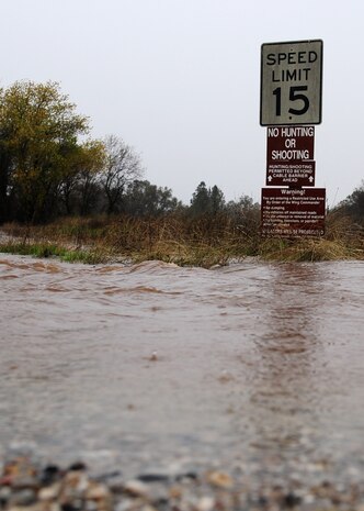 A sign on Gavin Mandery Dr. Beale Air Force Base, Calif., is surrounded by water during a storm Dec. 2, 2012. The storm caused road closures throughout base. (U.S. Air Force photo by Senior Airman Shawn Nickel/Released)