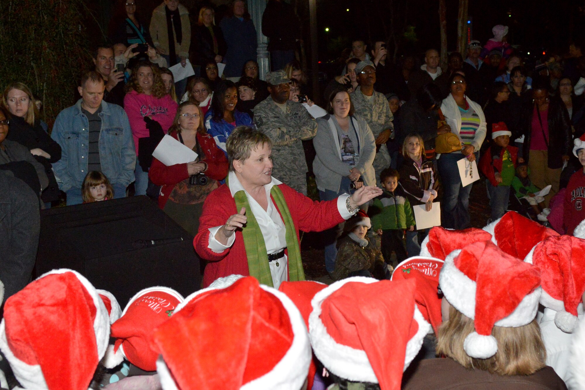 Parents and Shaw community members gather around memorial lake to watch High Hills and Shaw Heights Elementary students sing during the Shaw Christmas tree lighting, at Shaw Air Force Base, S.C. Nov. 29, 2012. The celebration attracted more than 300 participants. (U.S. Air Force photo by Airman 1st Class Ashley L. Gardner/ Released)