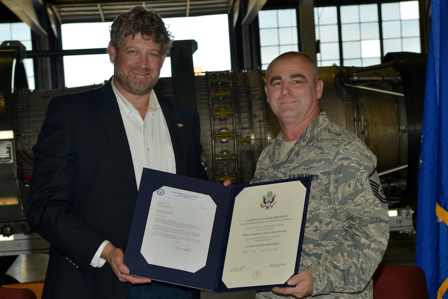 Retired U.S. Air Force Col. Robert Hopkins presents Master Sgt. James Stewart, 20th Aircraft Maintenance Unit assistant section chief, with his retirement certificate, at Shaw Air Force Base, S.C. Nov. 30, 2012. Stewart served a total of 24 years in the Air Force. (U.S. Air Force photo by Airman 1st Class Ashley L. Gardner/ Released)