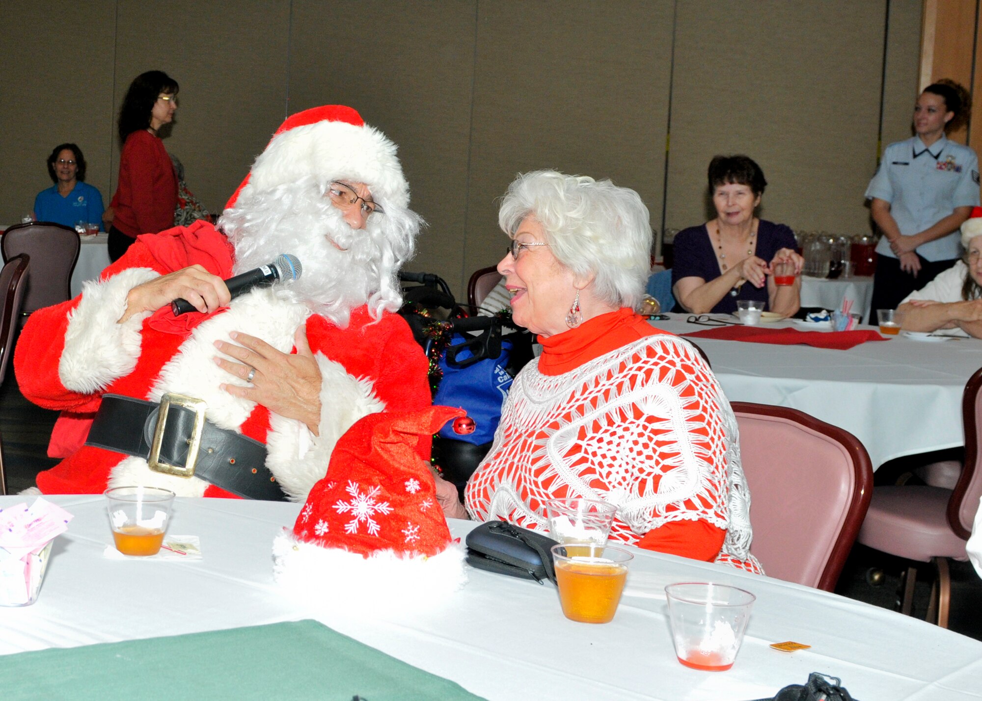 'Santa' says hello to an attendee at Tyndall's 26th Annual Golden Age Holiday Party Dec. 4. The party is for senior citizens from the Bay County Council on Aging, Sims Veterans Home and others from across the Panama City and Mexico Beach senior communities. During the party, guests are treated to cookies, pizza, finger sandwiches and dancing. The event began as way to say thank you to local veterans in senior communities during the holiday season. However, it has grown to include spreading holiday well wishes to local seniors as well. The Tyndall Chief’s Group sponsors the party. (U.S. Air Force photo by Susan Trahan)