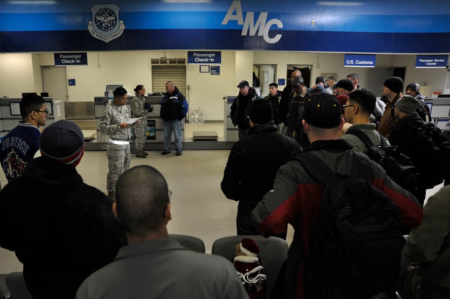 U.S. Air Force Tech. Sgt. Kenneth Escobar, 35th Force Support Squadron NCO in charge of lodging, briefs patriot express passengers on lodging and breakfast arrangements after their flight returned with a mechanical issue to Misawa Air Base, Japan, Dec. 4, 2012.  After finishing a 12-hour shift during an operational readiness exercise, Escobar spent the next 12-hours assisting service members and their families with lodging arrangements for the night. (U.S. Air Force photo by Staff Sgt. Nathan Lipscomb)