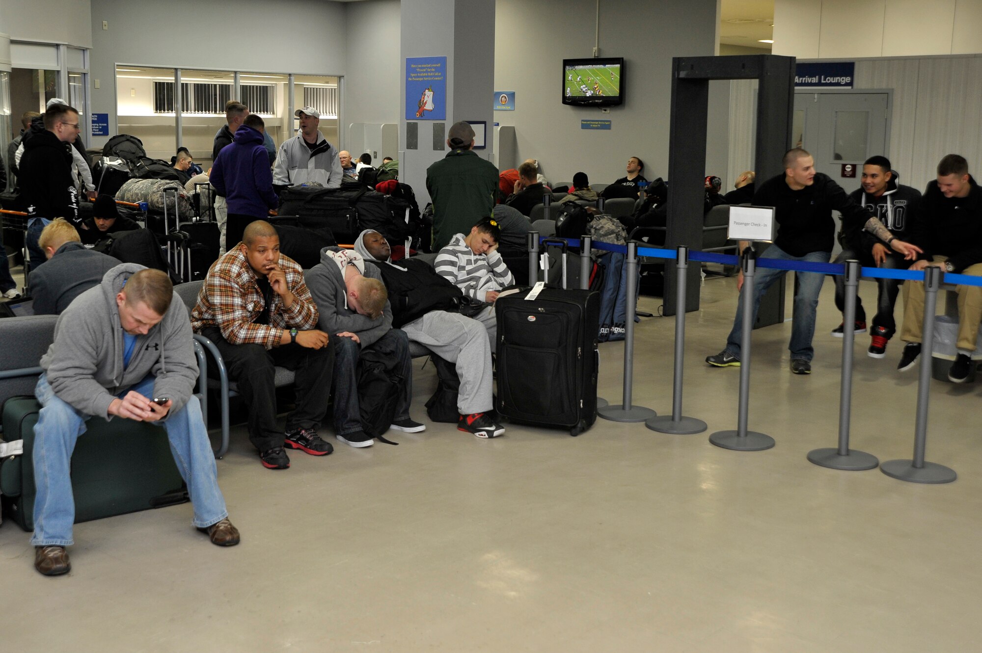 Patriot express passengers wait for buses to transport them to lodging after their flight returned with a mechanical issue to Misawa Air Base, Dec. 4, 2012. The base was in the middle of a operational readiness exercise, when more than 240 passengers arrived unexpectedly in need of lodging and food. (U.S. Air Force photo by Staff Sgt. Nathan Lipscomb)