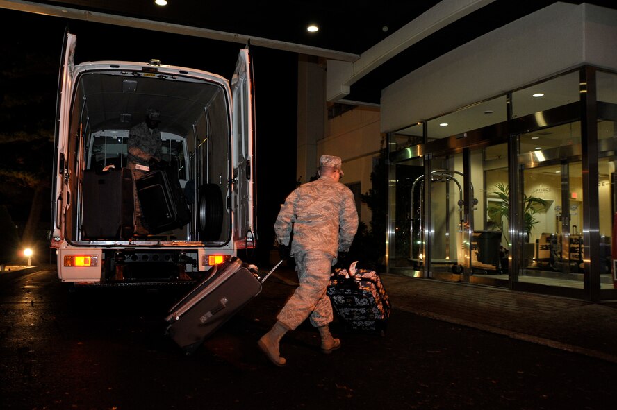 U.S. Air Force Airmen from the 35th Fighter Wing unload bags belonging to more than 240 unexpected patriot express passengers after their flight returned with a mechanical issue to Misawa Air Base, Japan, Dec. 4, 2012. The 35th Logistics Readiness Squadron provided drivers and transportation for the wing’s unexpected guests in addition to participating in an operational readiness exercise. (U.S. Air Force photo by Staff Sgt. Nathan Lipscomb)