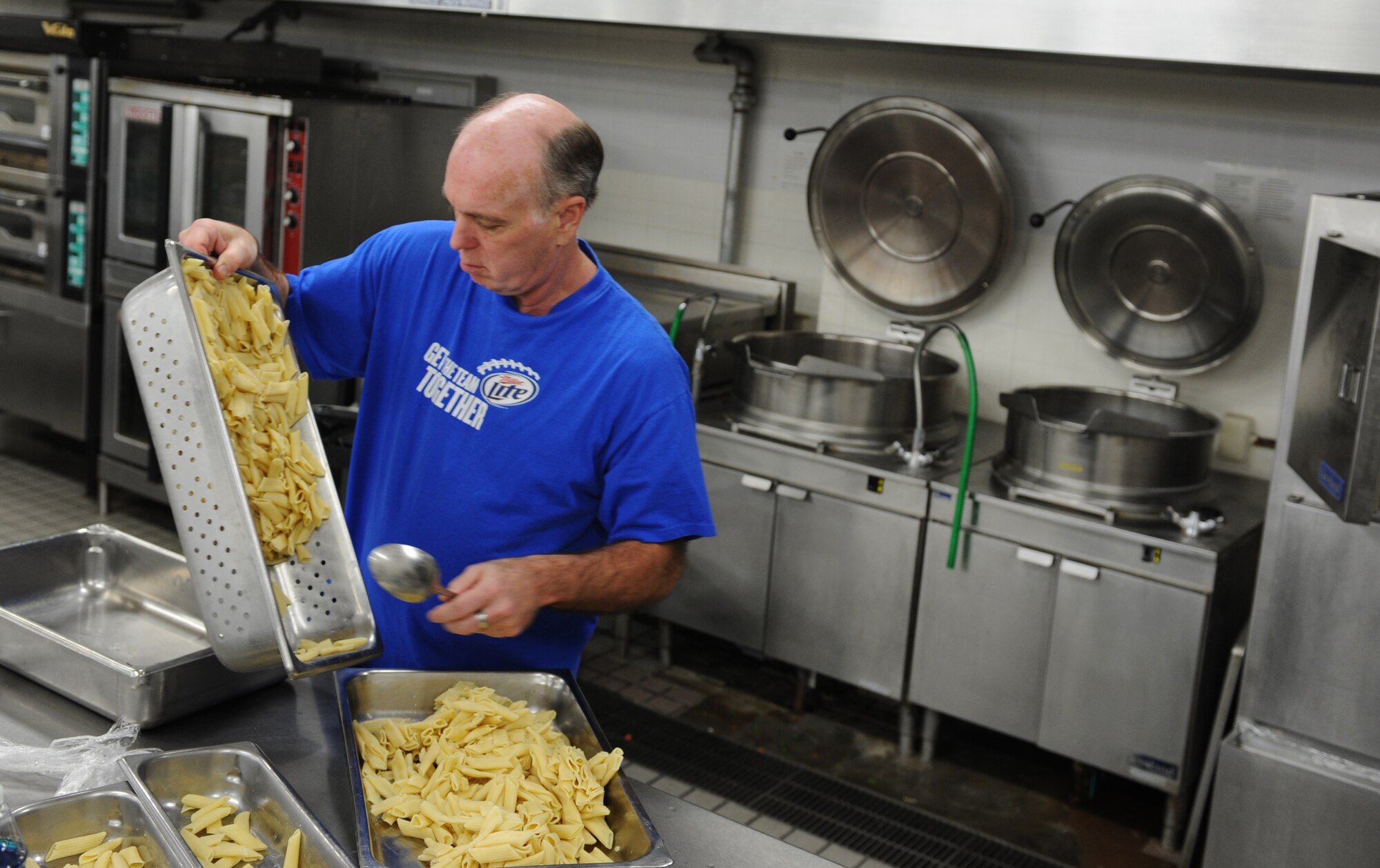 Paul Gotshall, Misawa Club Complex general manager, makes pasta for more than 240 unexpected patriot express passengers at Misawa Air Base, Japan, Dec. 4, 2012. The base provided the passengers with food and lodging to ease their stay after their flight unexpectedly returned due to mechanical issues. (U.S. Air Force photo by Airman 1st Class Kia Atkins)