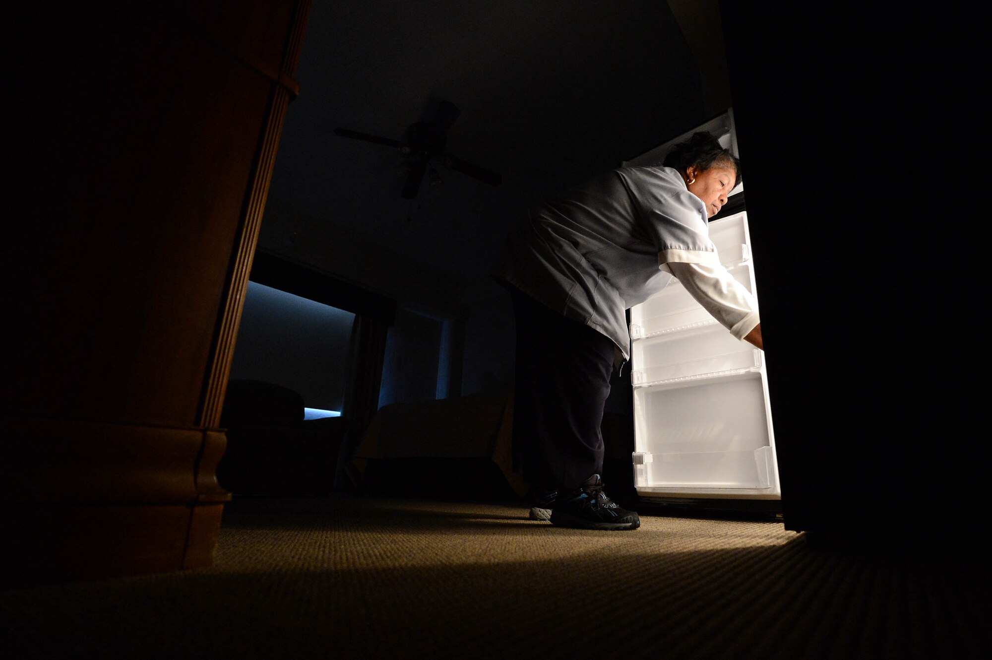 Geraldine Williams, Carolina Pines Inn housekeeper, cleans out a fridge at Shaw Air Force Base, S.C., Nov. 27, 2012. Williams is the Shaw Spotlight for the week of Dec. 3 to Dec. 7. (U.S. Air Force photo by Airman Nicole Sikorski/Released) 